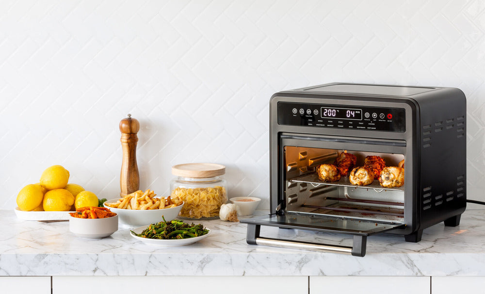 23L Digital Air Fryer Convection Oven with Rotisserie Cooking on Kitchen Countertop with Fresh Ingredients and Spices