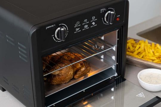 23L Air Fryer Oven in Black with chicken cooking, showing interior baking tray and wire rack, offering affordable, quality, value furniture.