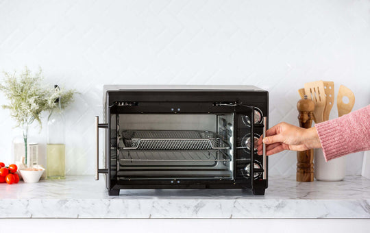 Affordable 30L air fryer convection oven with rotisserie option and open door, showcasing spacious cooking interior.