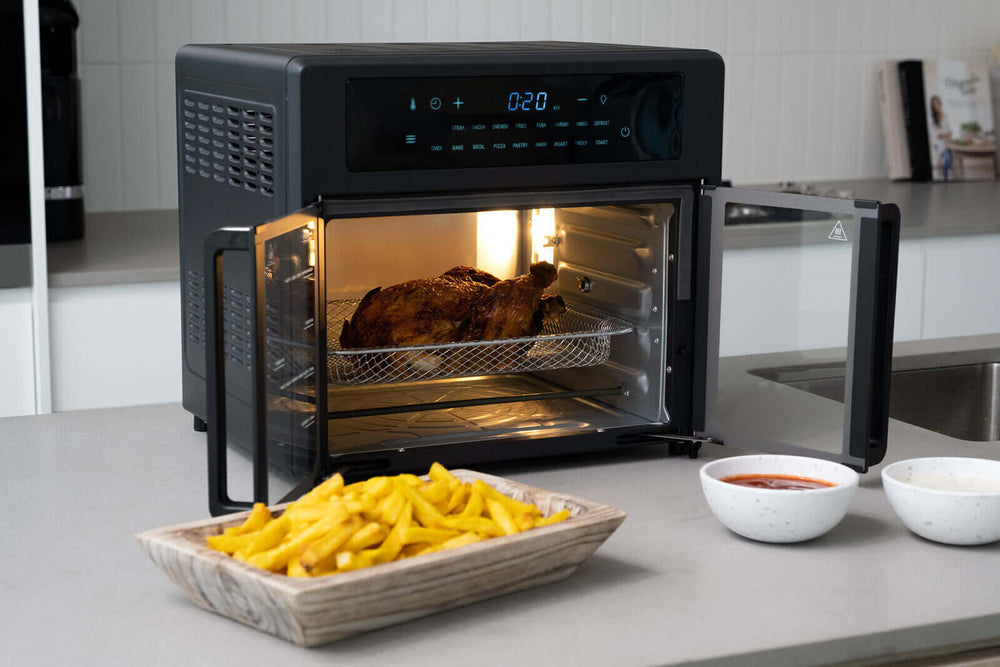 25L air fryer convection oven with French doors cooking chicken and fries, featuring advanced 360-degree cooking technology for quality meals