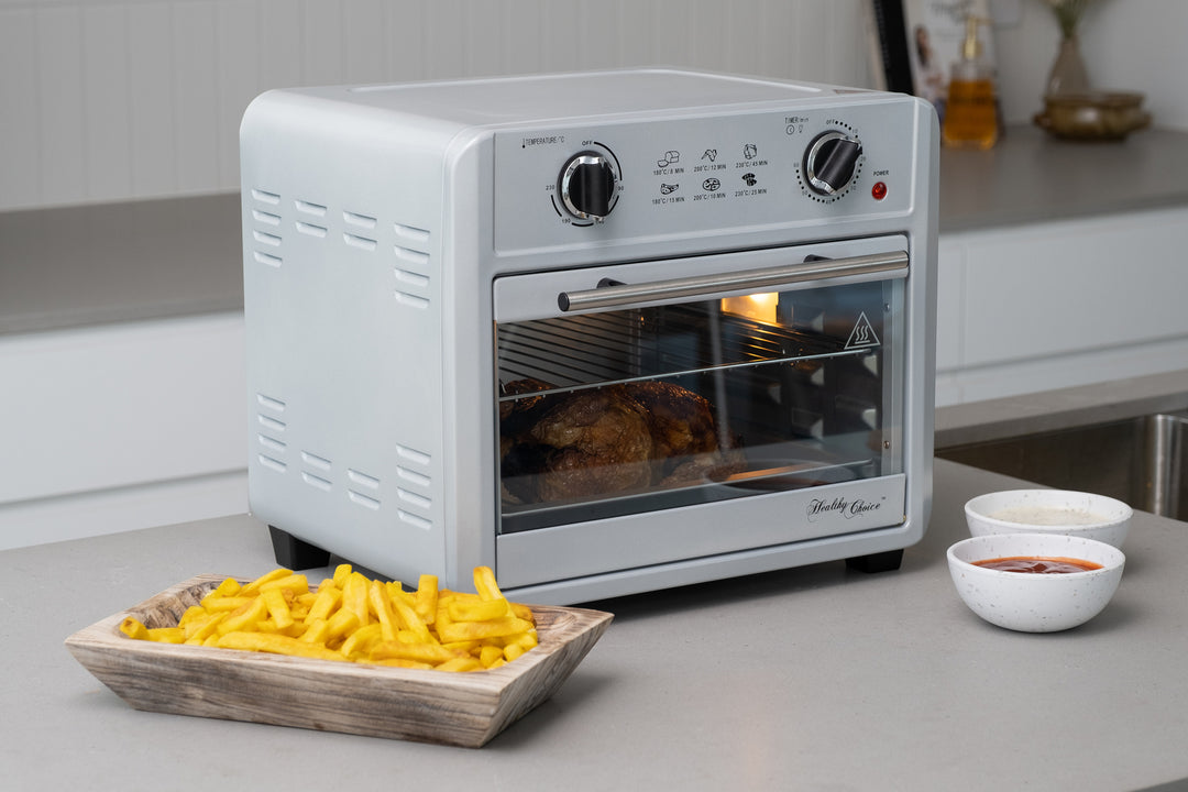 Silver 23L air fryer oven on a kitchen counter with fries in a tray and bowls of dips, showcasing value, affordability, and quality furniture.