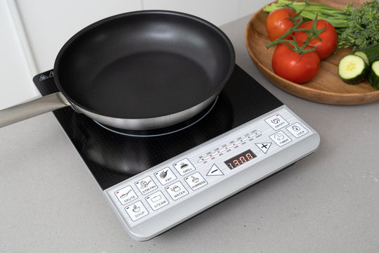 Digital induction cooker with pan on top, showcasing a modern value furniture kitchen solution. Affordable, quality cooking made easy.