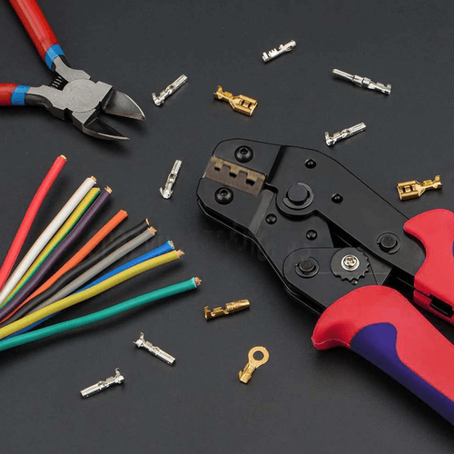 Affordable assorted waterproof insulated electrical connectors with crimp terminals and pliers on dark background.