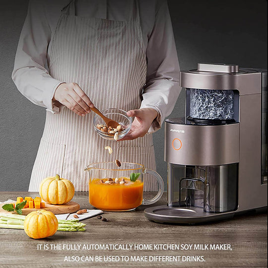 Person using Joyoung High Speed Power Blender Food Processor to make fresh pumpkin soup in a modern kitchen.