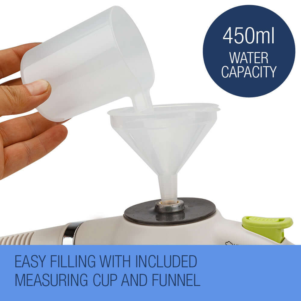 User filling a portable steam cleaner with water using a measuring cup and funnel, showcasing its 450ml capacity.