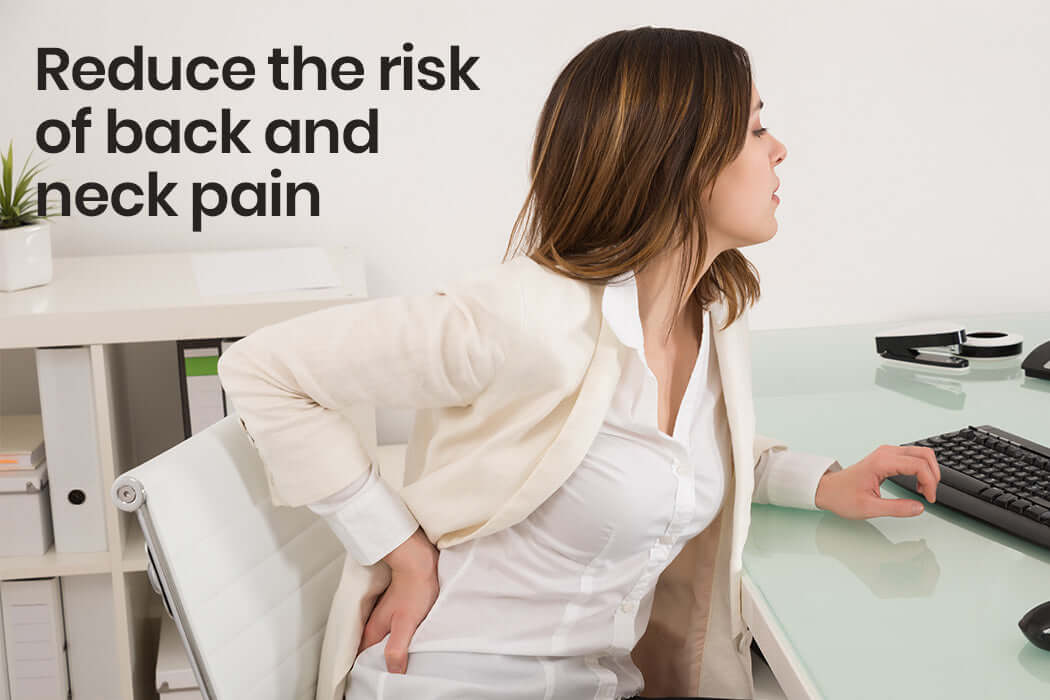 Woman experiencing back pain at desk, highlighting ergonomic solutions for comfort and health.