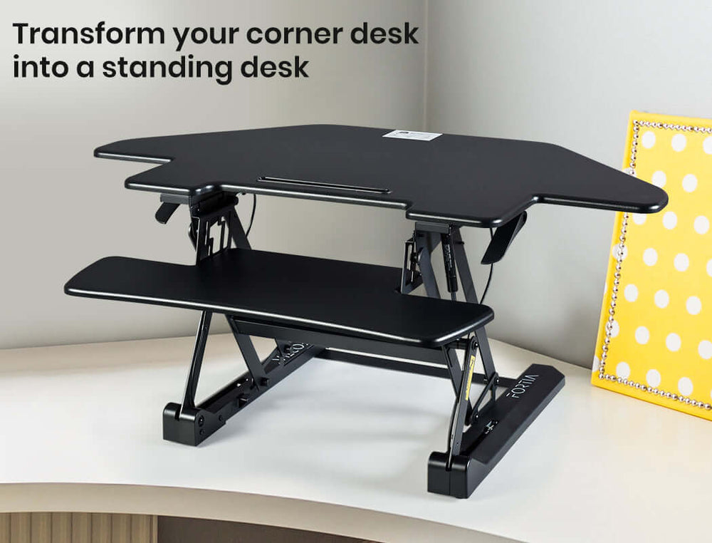 Fortia Corner Desk Riser in black, adjustable height for ergonomic standing while working or studying.