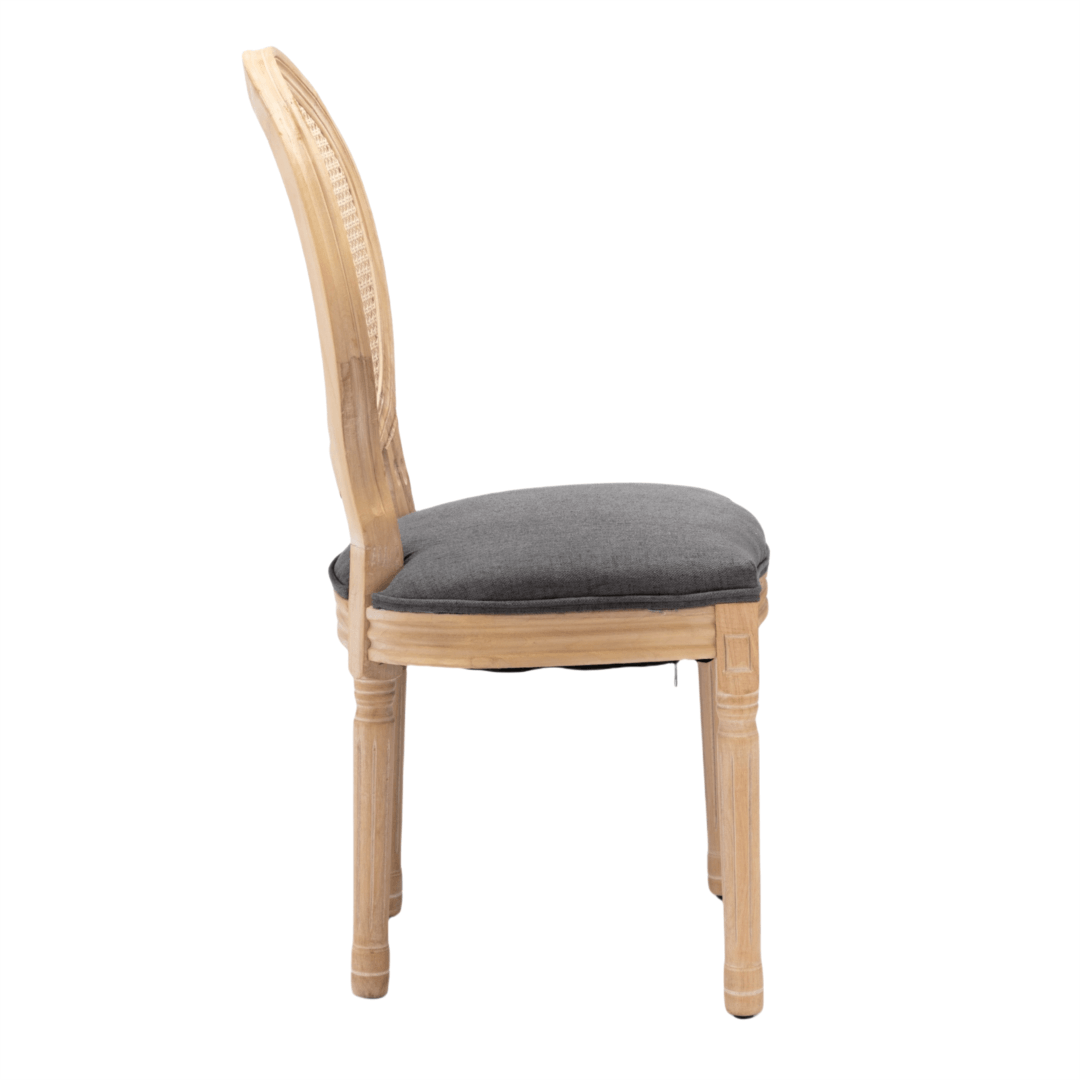 Side view of AADEN rattan dining chair with solid wood legs and grey upholstered seat, showcasing its elegant design.