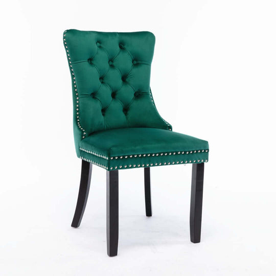 Affordable green velvet dining chair with deep tufted back and stud trim, supported by solid wood legs for quality design.