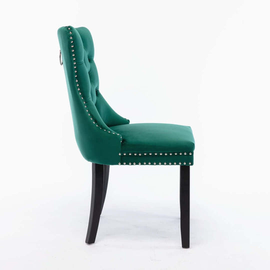 Side view of a green velvet dining chair with tufted back, studded trim, and solid wood legs, showcasing modern luxury design.