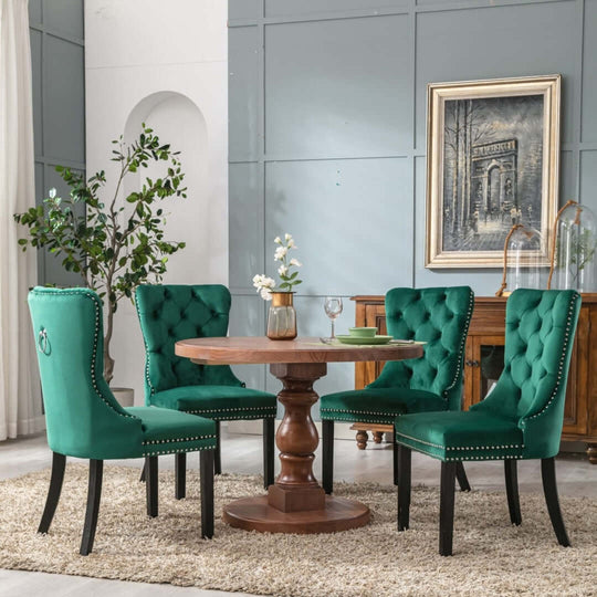 Elegant green velvet dining chairs with tufted backs around a wooden table in a stylish modern dining room setting.