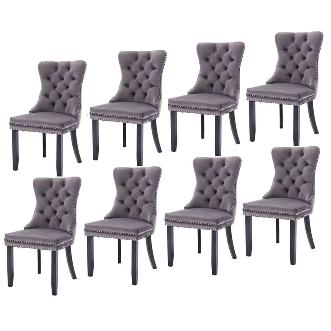 8 gray velvet dining chairs with tufted high back, solid wood legs, stud trim, and modern design.