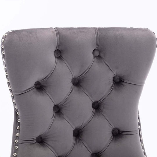 Gray tufted velvet dining chair backrest with stud trim detailing