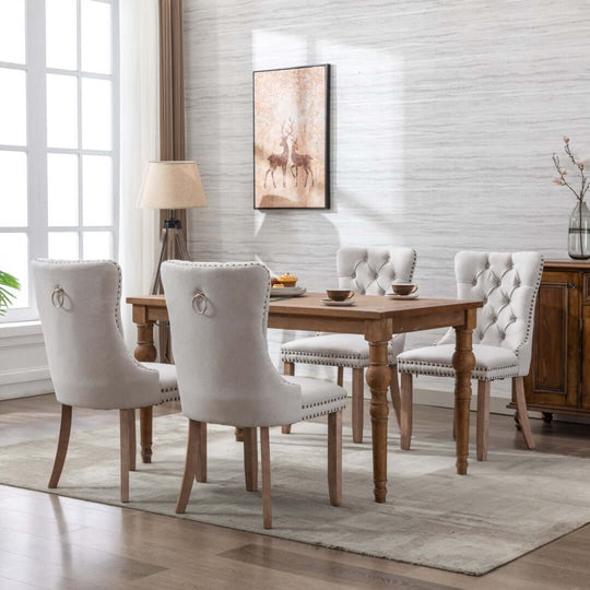 Elegant dining room with tufted chairs and wooden table, showcasing stylish decor and affordable luxury.