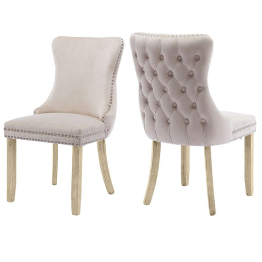 Velvet upholstered dining chairs with tufted wingback, stud trim, and solid wood legs; perfect for modern kitchen decor