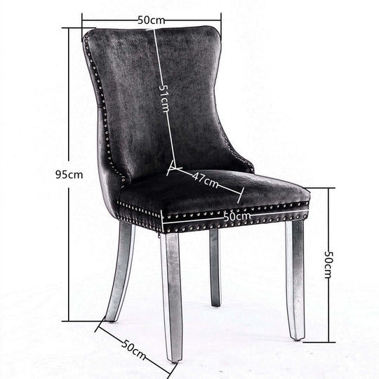 Velvet upholstered dining chair with tufted wingback, stud trim, and solid wood legs, dimensions displayed.