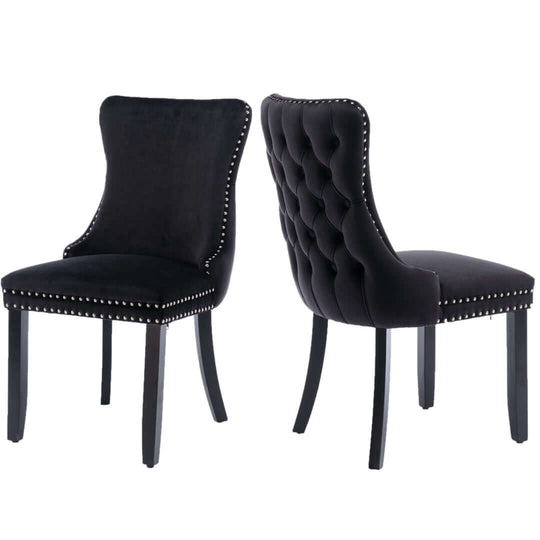 Black velvet upholstered dining chairs with tufted back, studs trim, and solid wood legs, showcasing modern elegant style.