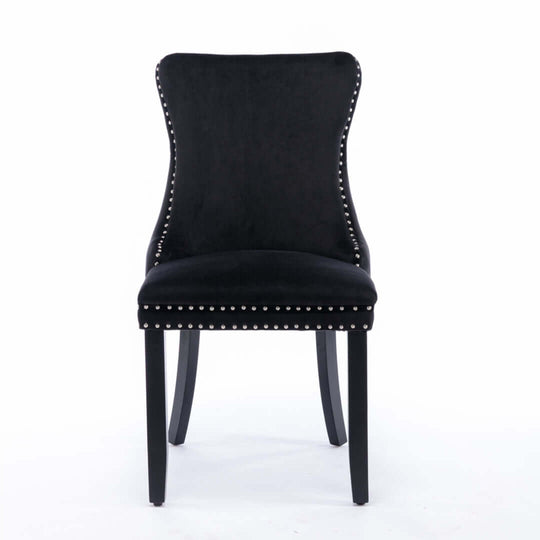 Black velvet upholstered dining chair with studded trim and solid wood legs, modern elegant style.