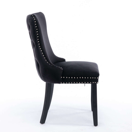 Velvet upholstered dining chair with studs trim and solid wood legs, side view, black.