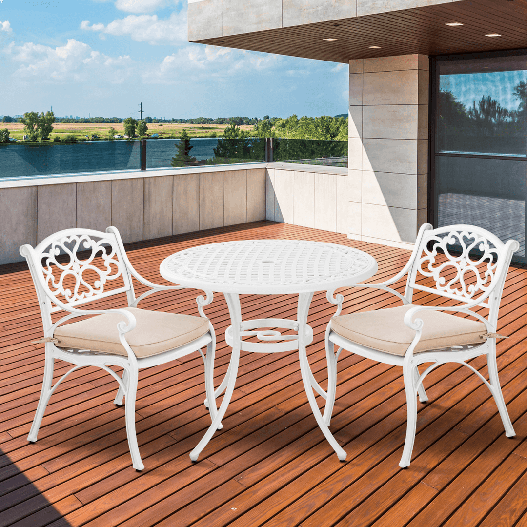 Marco Aluminium 3-piece setting on a balcony with white chairs and beige cushions, perfect for outdoor relaxation.