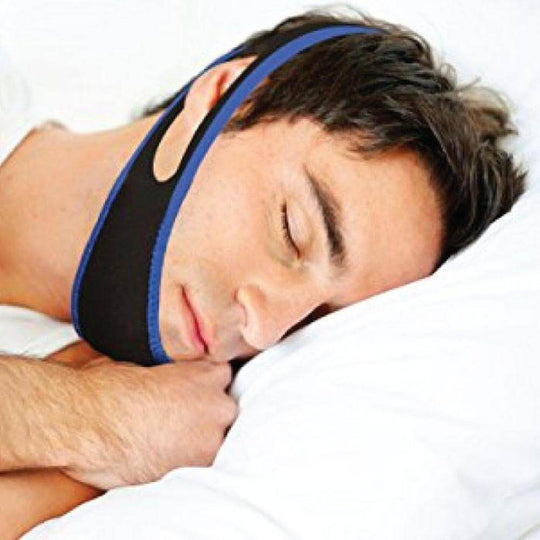 Man sleeping comfortably wearing an adjustable anti snoring chin strap, promoting quality sleep and snore reduction.