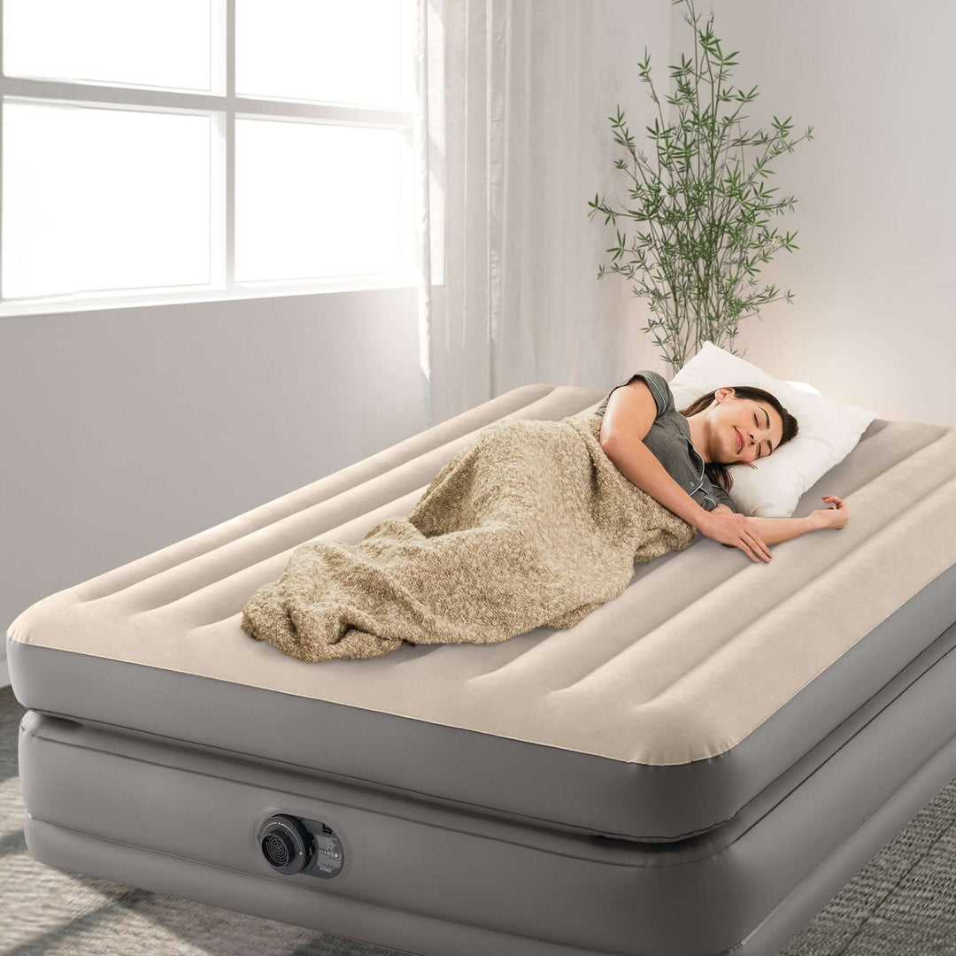 Comfortable queen air mattress with girl sleeping, showcasing luxury, quality and affordability for a refreshing night's sleep.