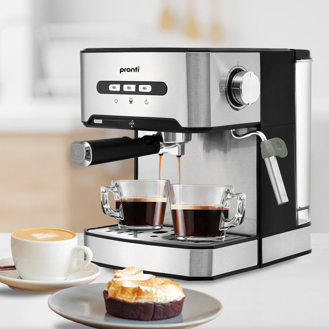 Pronti 1.6L Automatic Coffee Espresso Machine with Steam Frother brewing espressos, alongside a cappuccino and pastry on a kitchen counter