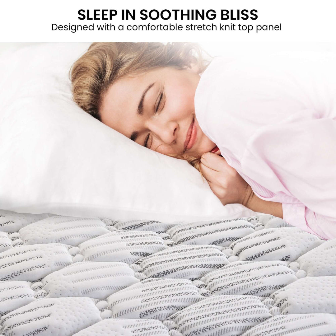 Woman enjoying restful sleep on the Laura Hill Essential mattress featuring a soft stretch knit top panel.