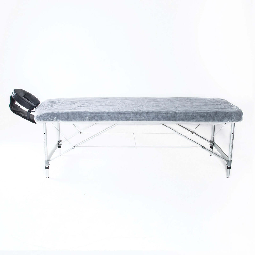 Affordable foldable massage table with gray cover and adjustable headrest for comfort and luxury in DIY massage sessions.