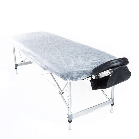 15pcs disposable massage table sheet cover on foldable table, featuring protective paper material for hygiene and comfort.