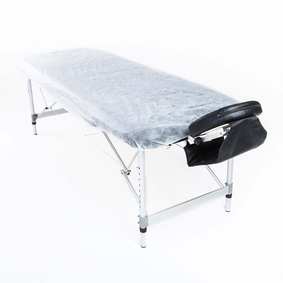 Disposable massage table sheet cover on a foldable massage table, showcasing affordable quality for a hygienic massage experience.