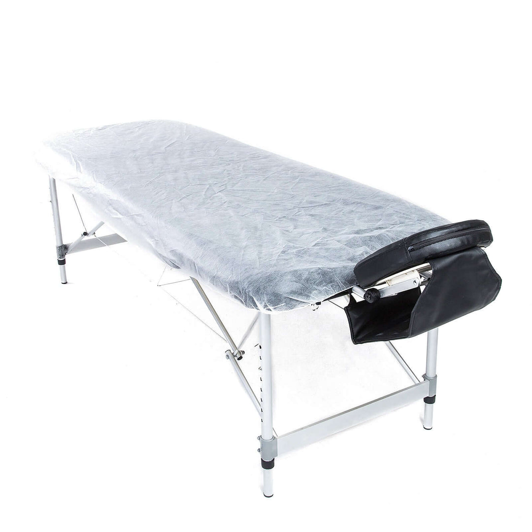 Disposable massage table sheet cover on foldable table, promoting affordable luxury and quality for DIY spa treatments.