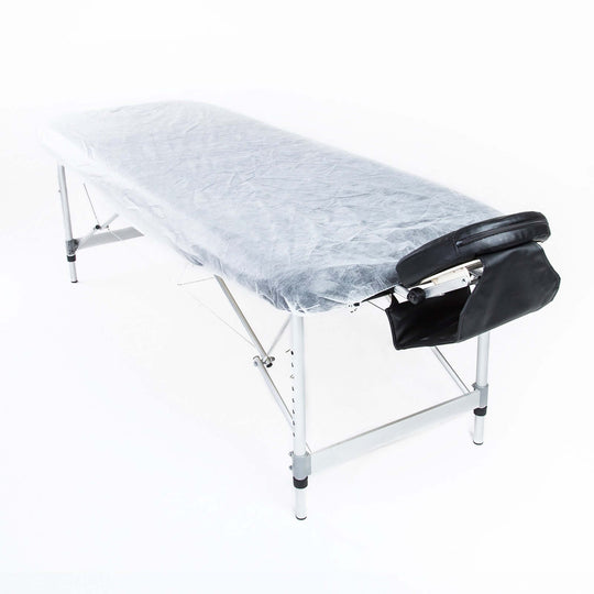 Disposable massage table cover on a foldable massage table, showcasing affordable and quality aseptic bedding.