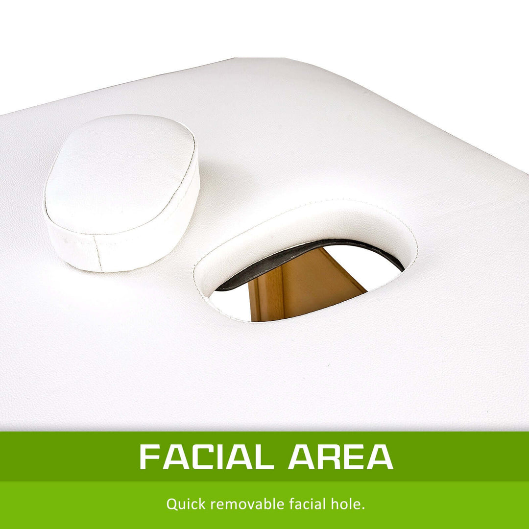 Close-up of removable facial hole and cushion on a white wooden massage table, highlighting comfort and functionality.