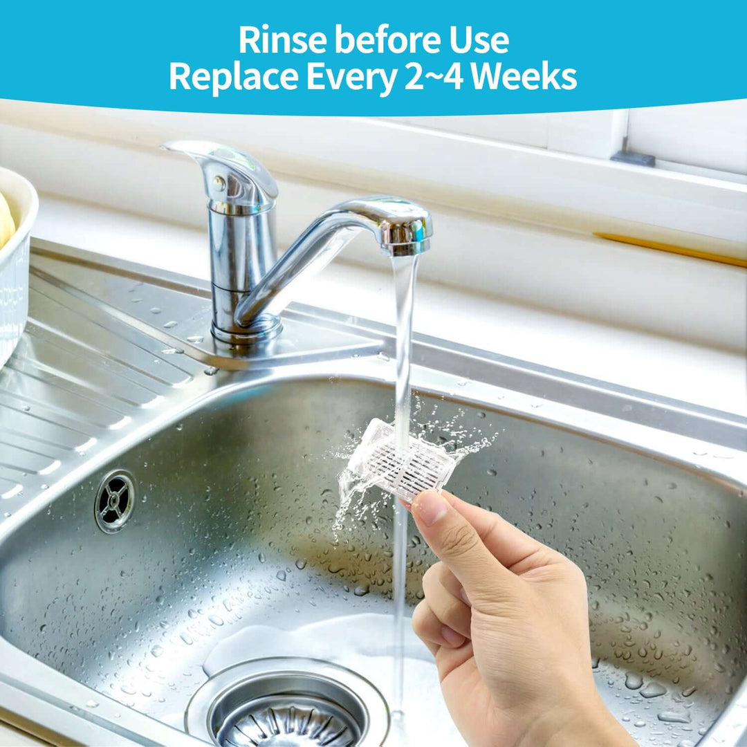 Hand rinsing a pet fountain filter under running water in a kitchen sink, emphasizing maintenance tips.