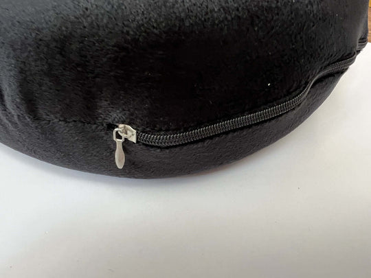 Close-up view of the Yes4homes U-shaped travel pillow showing a black fabric cover and zipper detail.