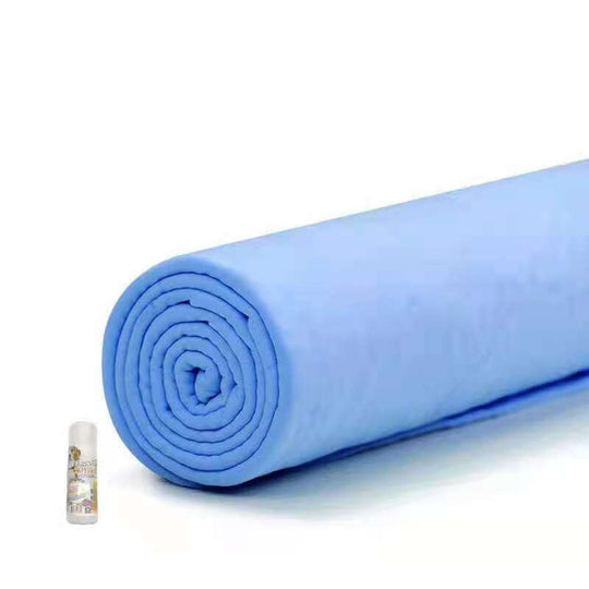 Rolled blue pet towel next to a small bottle, showcasing its affordable, absorbent, and durable design for pets.