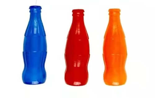 Colorful toy bottle treat holders for dogs in blue, red, and orange. Affordable, quality toy for healthy gums and teeth.