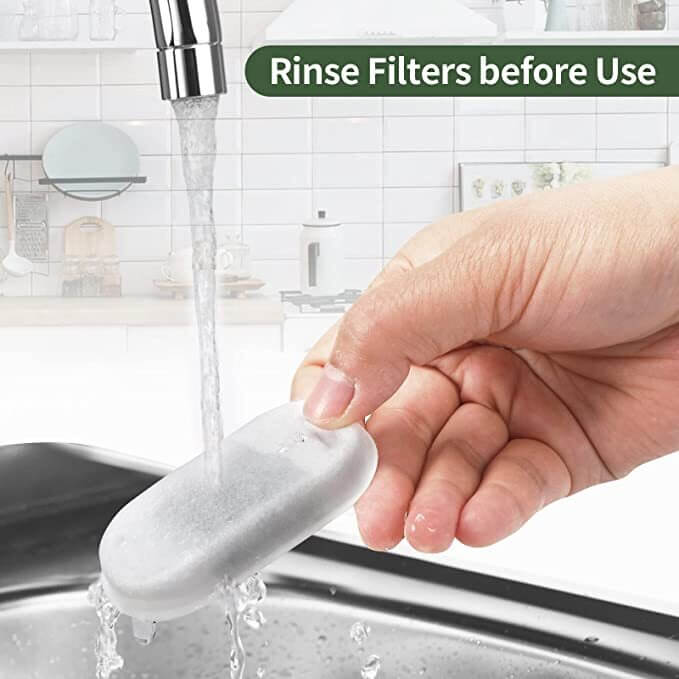 Hand rinsing pet fountain filter under water with sink and kitchen background, promoting clean and fresh water for pets.