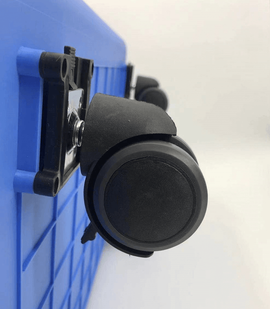 Close-up of black wheel on a blue dog crate, showcasing portability and ease of movement for pet carriers.