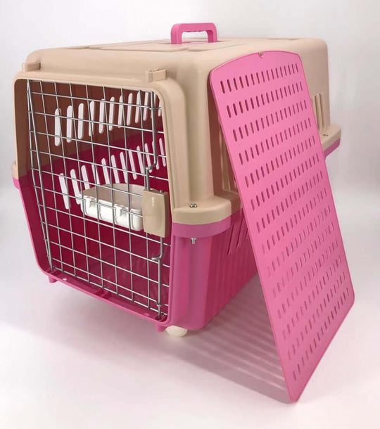 Affordable pink dog and cat crate with removable tray and bowl, large entrance, ventilation, and wheels for easy transport.