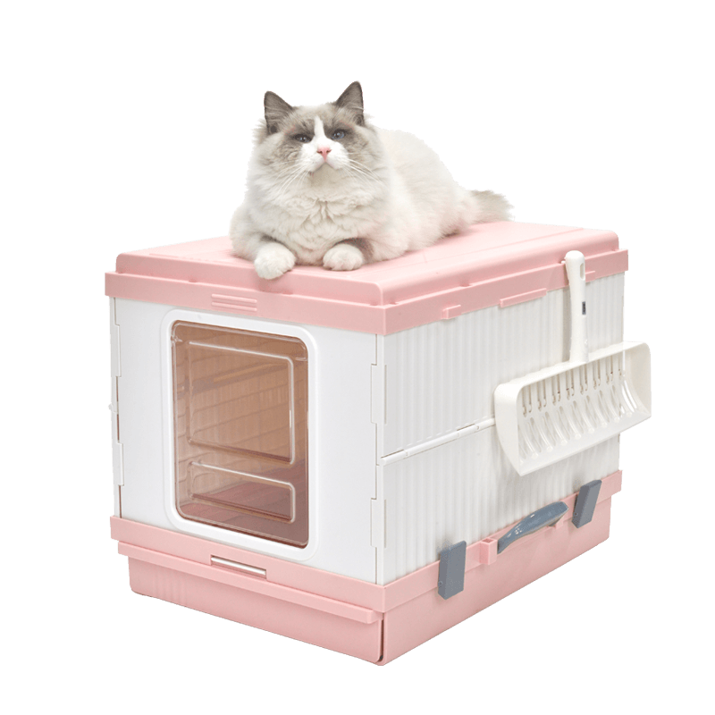 Pink XL portable cat toilet litter box with a fluffy cat resting on top, featuring a scoop and hooded design for odor control.