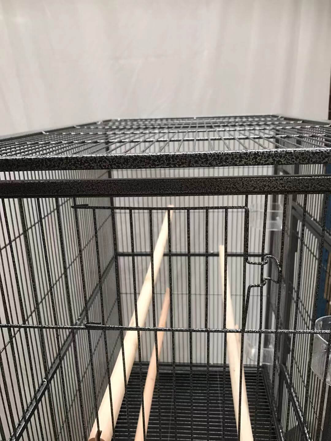 Interior view of YES4PETS bird cage showing wooden perches and spacious layout for pet comfort.