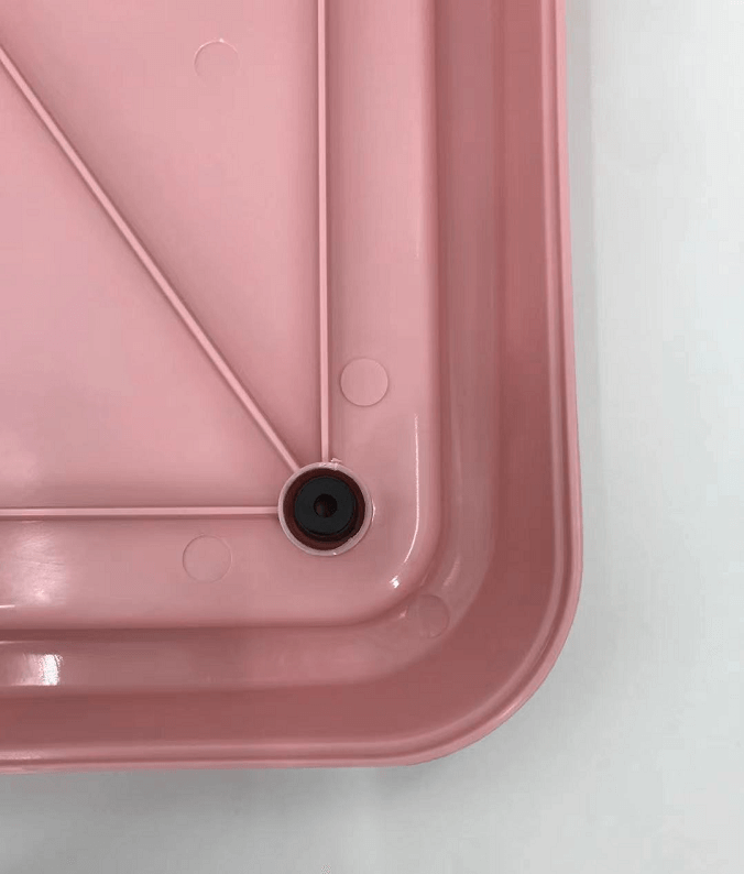 Close-up of YES4PETS pink portable dog potty training tray, showcasing the functional design and drainage hole.