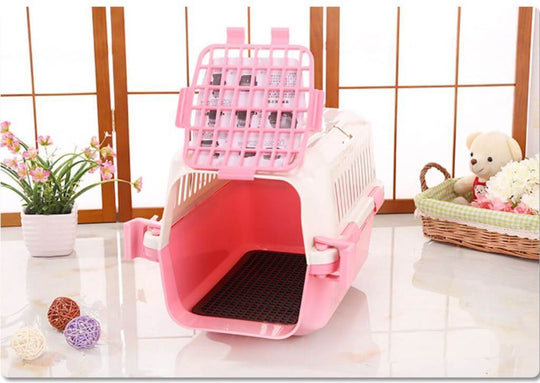 Lightweight pink pet carrier for small dogs and cats, designed with a spacious interior and ergonomic handle for travel.