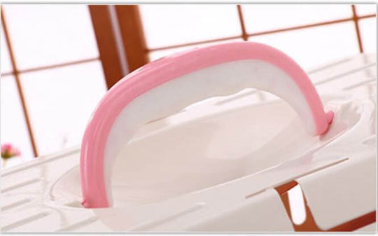 Pink ergonomic handle of YES4PETS pet carrier, designed for easy transport and convenient storage.