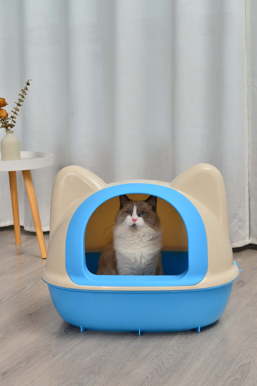 Large blue hooded cat litter box with a cat inside, featuring easy access and privacy for your pet. Affordable and quality design.