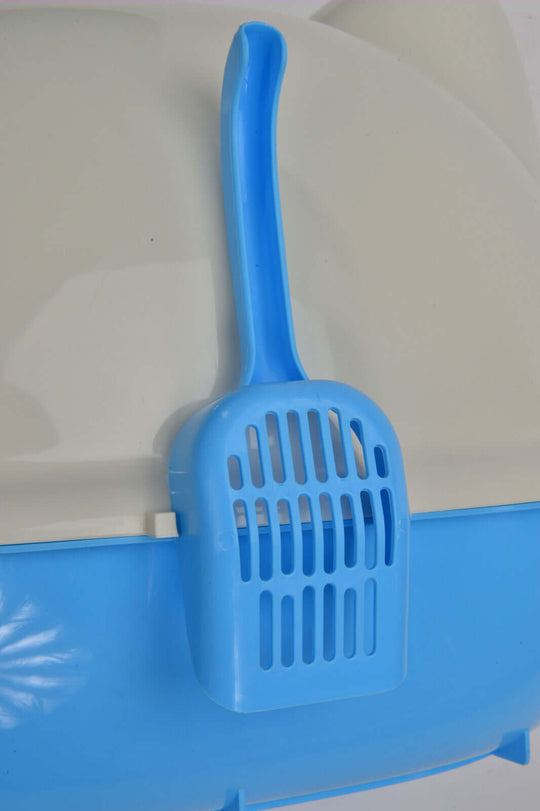 Blue litter scoop hanging on the side of a hooded cat litter box tray for easy access and cleaning.