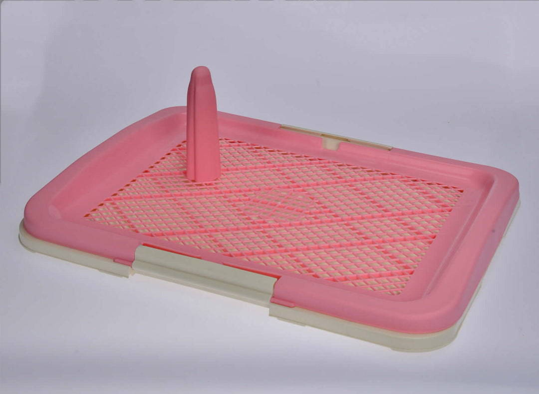 Medium portable dog potty training tray in pink with a grid layer and pole for mess isolation.