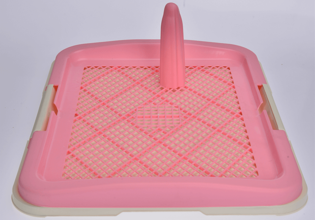 Portable pink dog potty training tray with grid layer and pole for easy waste removal.